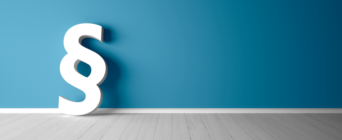 KI generiert: Ein großes, weißes Paragraphensymbol steht vor einer blauen Wand.